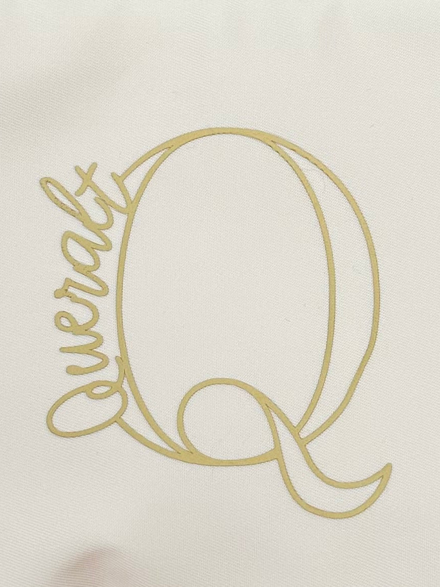 White pouch with a gold logo on a beige background