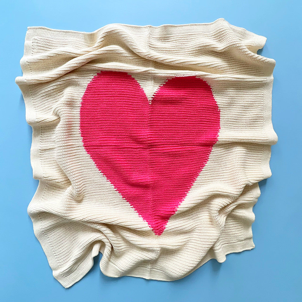 Beige fabric with a pink heart on a blue background